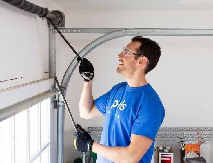 Technician repairing or replacing a garage door opener for smooth and reliable operation.